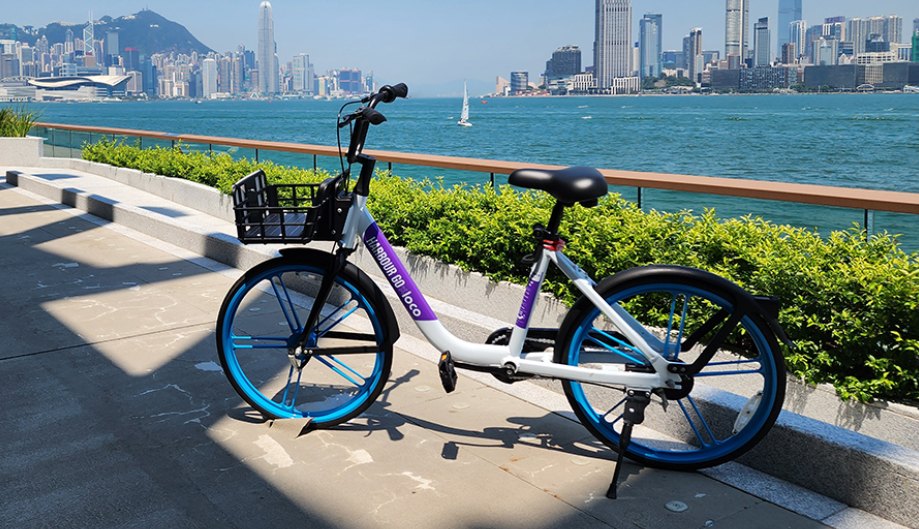 A HARBOUR GO bike on the Victoria Harbour promenade, facing Hong Kong Island